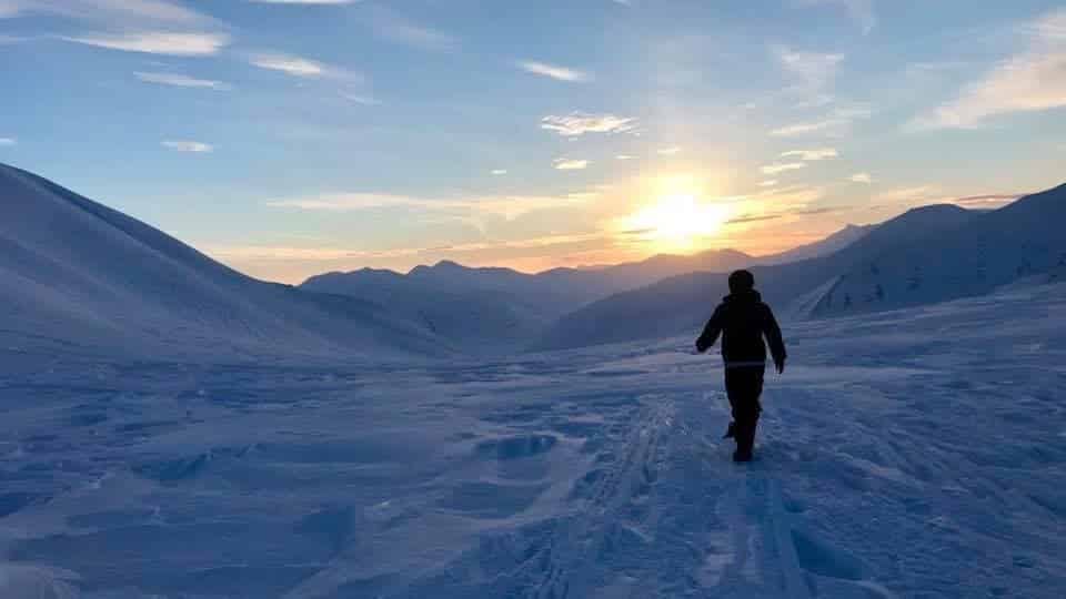 image walking towards the light in longyearbyen courtesy of visit svalbard