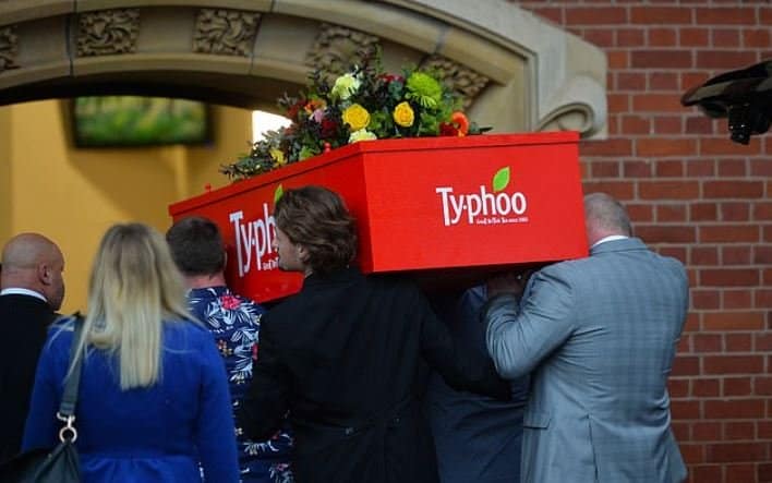 image woman buried in tea bag box coffin