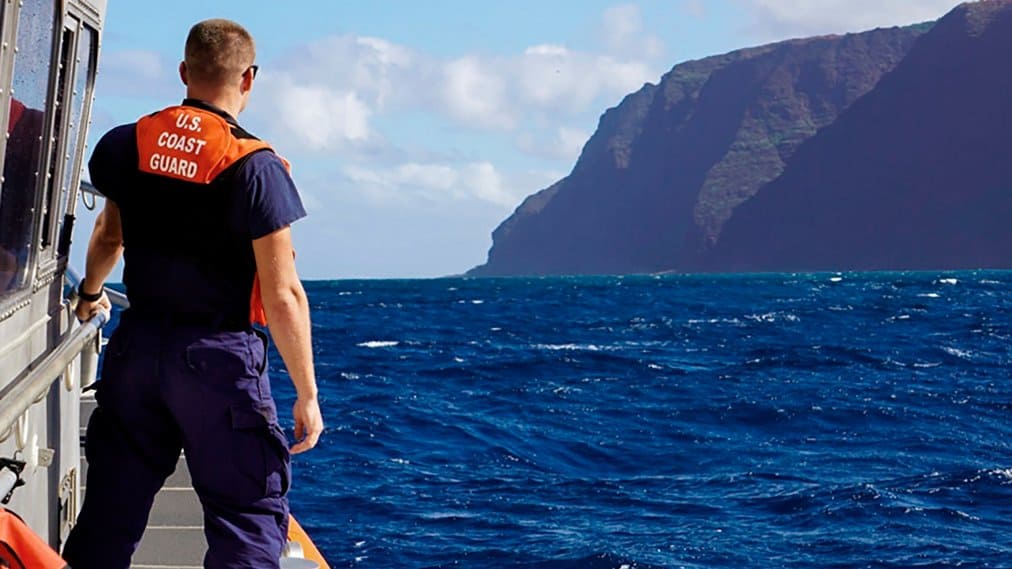 In this photo released by the U.S. Coast Guard, Coast Guard Cutter William Hart moves toward the Na Pali Coast on the Hawaiian island of Kauai on Friday, Dec. 27, 2019, the day after a tour helicopter disappeared with seven people aboard. Authorities say wreckage of the helicopter has been found in a mountainous area on the island. (Lt. j.g. Daniel Winter/U.S. Coast Guard via AP)