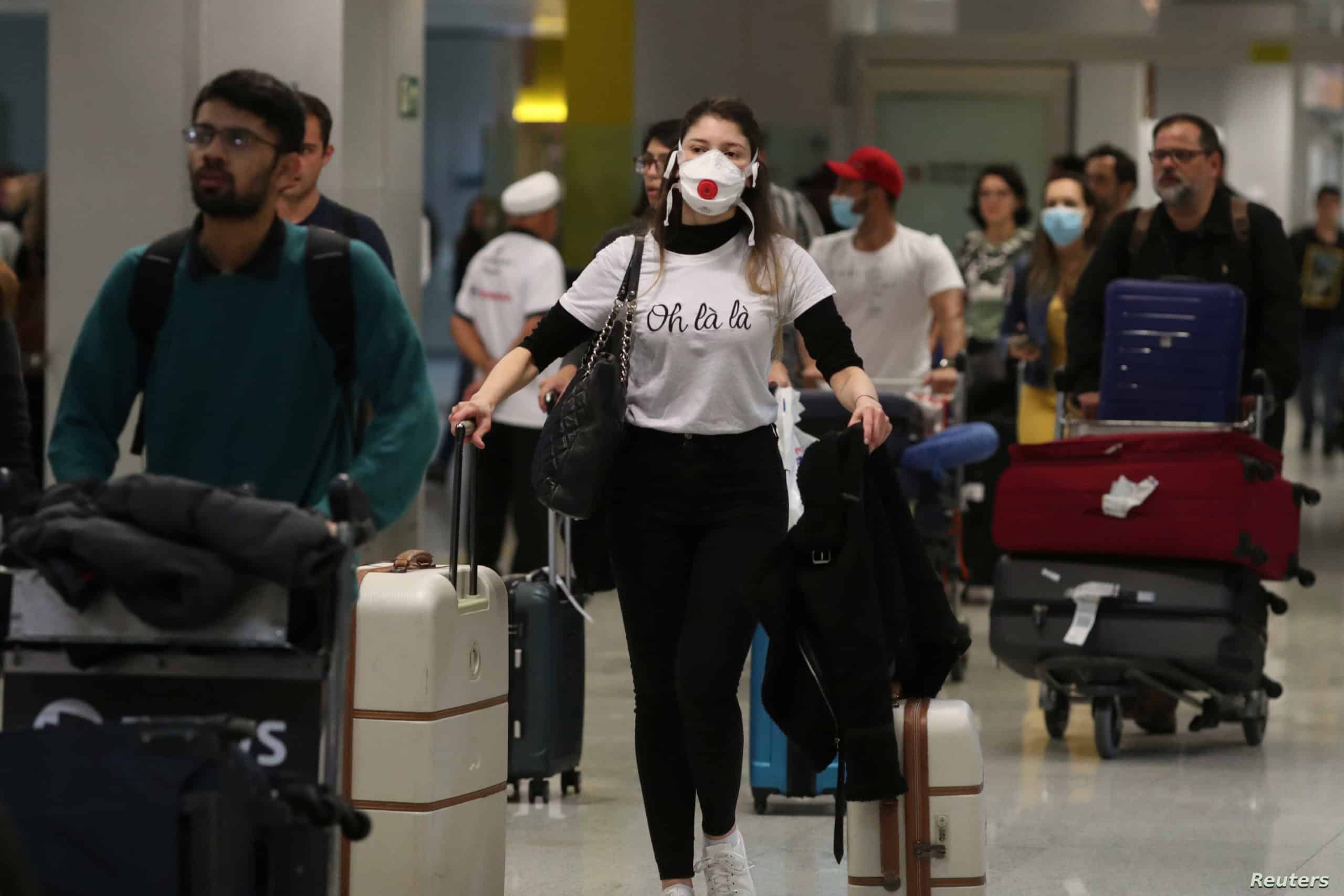 A traveller, wearing a mask as a precautionary measure to avoid contracting coronavirus, arrives on a flight from Europe at Guarulhos International Airport in Guarulhos, Sao Paulo state, Brazil, February 27, 2020. REUTERS/Amanda Perobelli