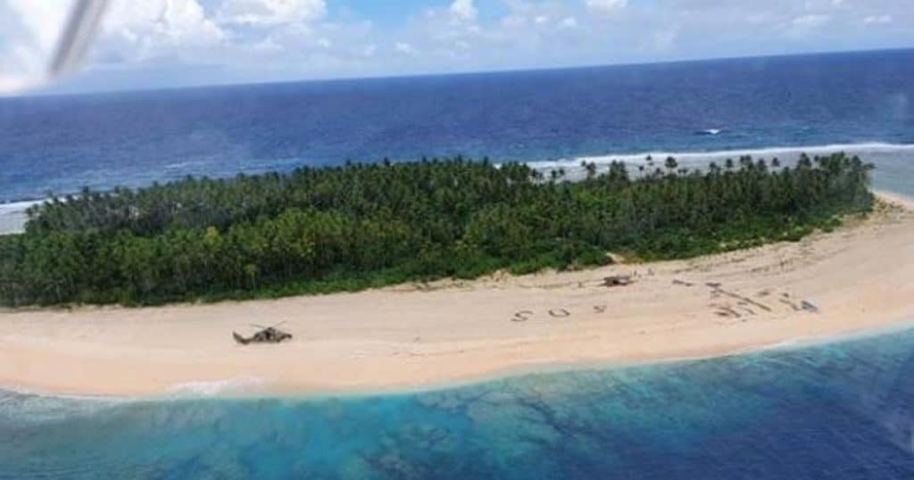 image giant sos in sand leads to rescue of 3 men from uninhabited pacific isle pikelot island