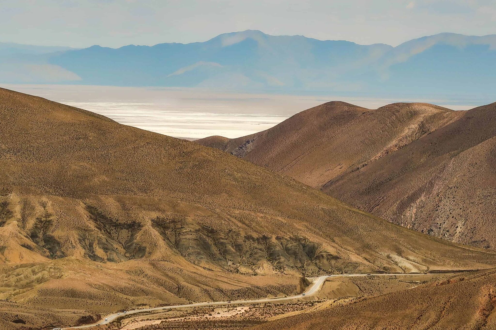 brown mountains near body of water during daytime