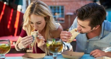 Two people eating tacos