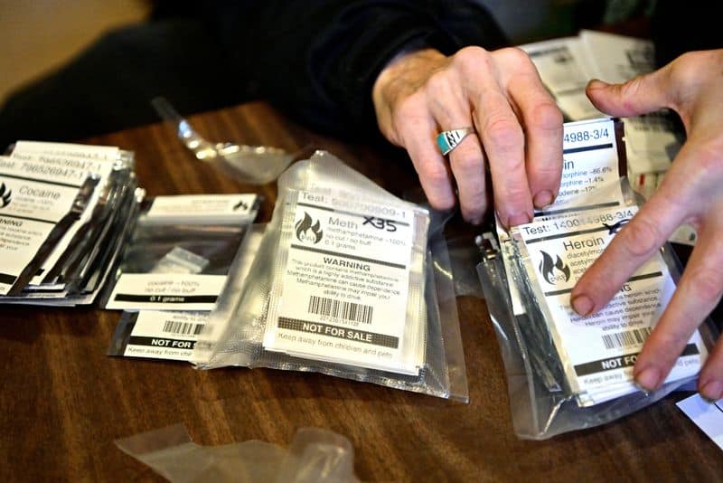 Dave Hamm, an ethical substance peer navigator with the Vancouver Area Network of Drug Users (VANDU), distributes packets of drugs tested for contaminants, as the province of British Columbia decriminalized the possession of small amounts of cocaine, methamphetamine, MDMA and opioids like heroin, fentanyl and morphine, in the Downtown Eastside of Vancouver, British Columbia, Canada January 31, 2023. REUTERS/Jennifer Gauthier