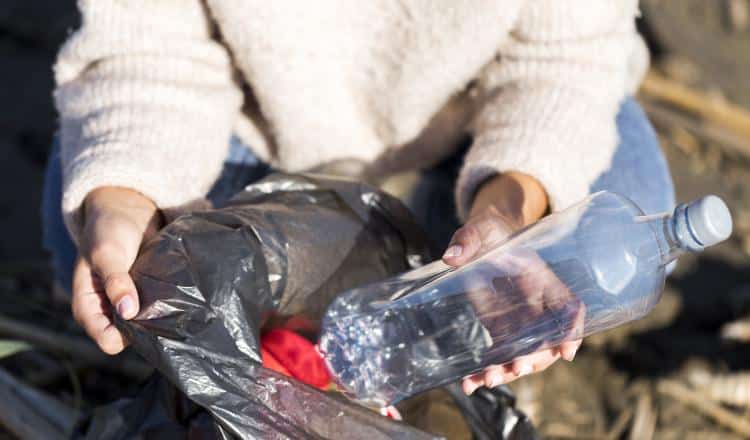 woman-picking-trash-from-seaside