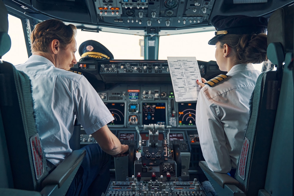 Pilot,And,Female,First,Officer,Seated,In,The,Flight,Deck
