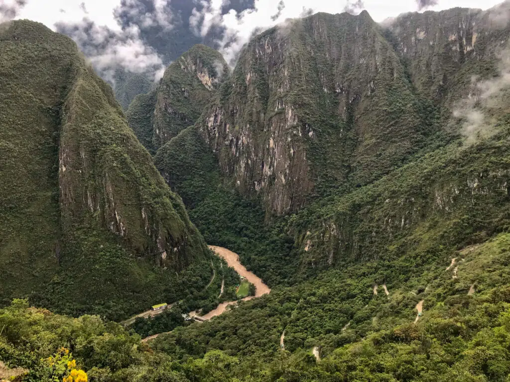 image panoramic shot brown river middle green mountains majestic machu picchu