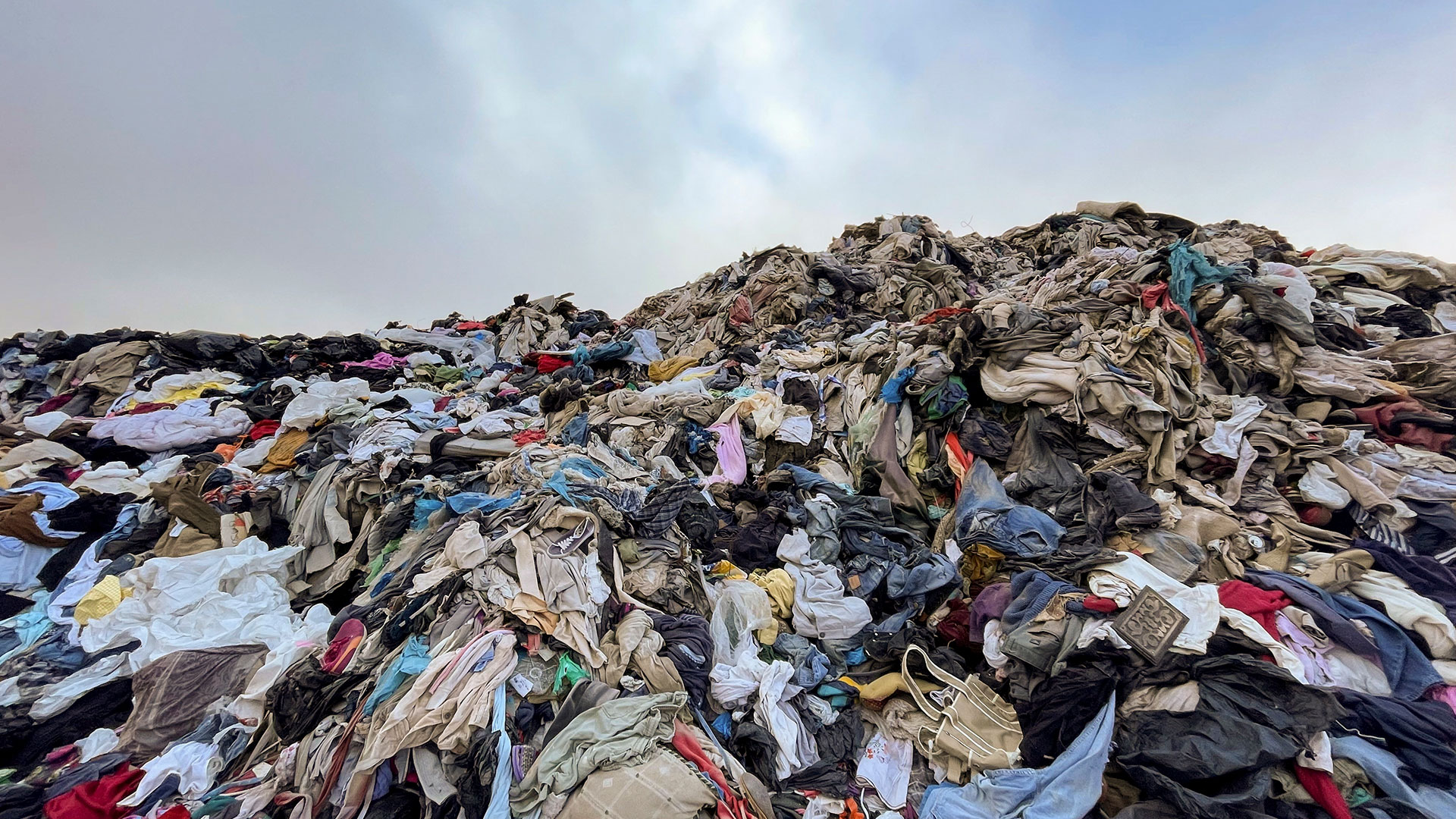 View of used clothes discarded in the Atacama desert, in Alto Hospicio, Iquique, Chile, on September 26, 2021. - EcoFibra, Ecocitex and Sembra are circular economy projects that have textile waste as their raw material. The textile industry in Chile will be included in the law of Extended Responsibility of the Producer (REP), forcing clothes and textiles importers take charge of the waste they generate. (Photo by MARTIN BERNETTI / AFP)