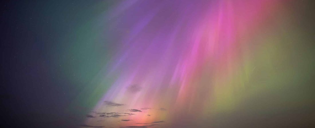 The aurora borealis, also known as the northern lights, glow on the horizon at St. Mary's Lighthouse in Whitley Bay on the North East coast, England, Friday, May 10, 2024. (Owen Humphreys/PA via AP)