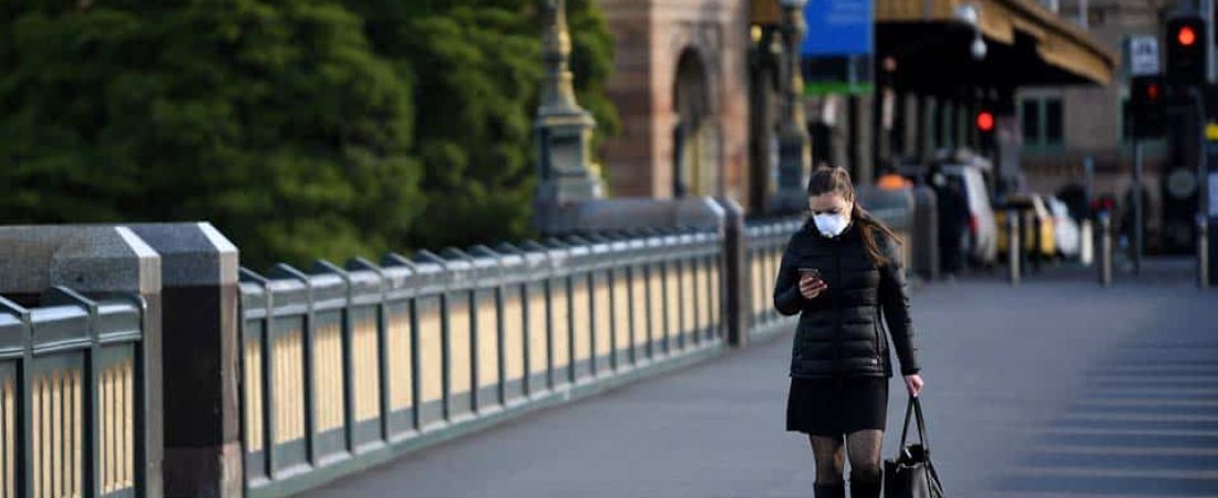 Melbourne (Australia), 02/08/2020.- A person wearing a face mask walks across Princes Bridge in Melbourne, Australia, 03 August 2020. Victorian Premier Daniel Andrews has foreshadowed major changes to workplace restrictions on 03 August, after Melburnians had their first night under curfew. EFE/EPA/JAMES ROSS AUSTRALIA AND NEW ZEALAND OUT