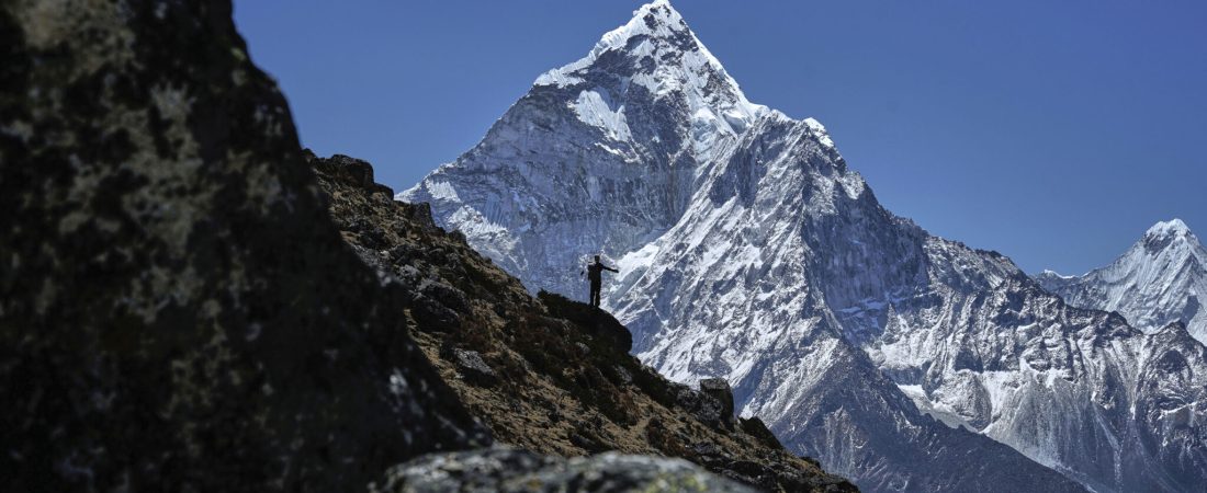 A mountaineer is silhouetted against Mount Ama Dablam on his way to the summit of Mount Everest in Nepal, April 24, 2025. (AP Photo/Pasang Rinzee Sherpa)