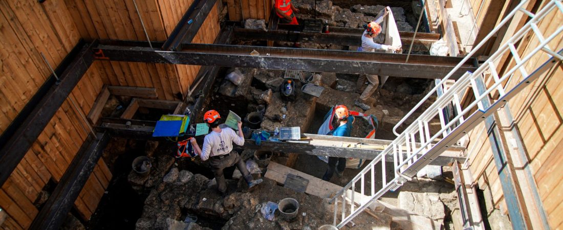 Archaeological workers wearing hard hats dig 4 meters (13 feet) underground during excavations outside Notre-Dame Cathedral in Paris, Monday, June 1, 2026. (AP Photo/Nicolas Garriga)