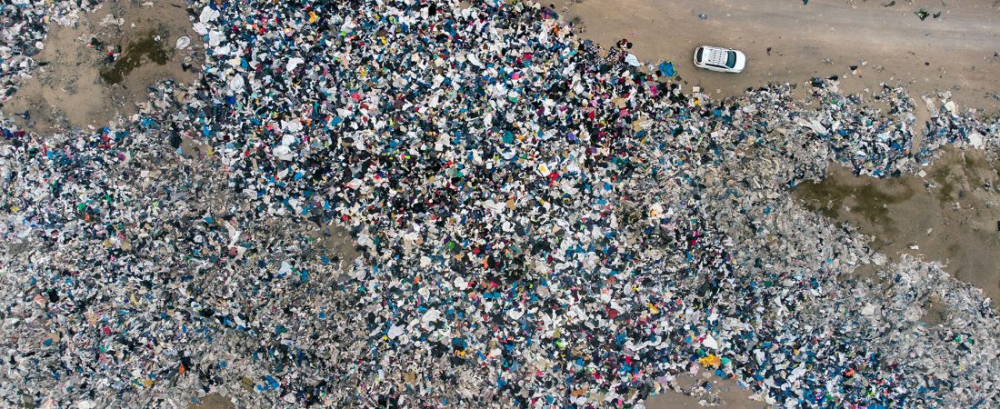 Aerial view of used clothes discarded in the Atacama desert, in Alto Hospicio, Iquique, Chile, on September 26, 2021. - EcoFibra, Ecocitex and Sembra are circular economy projects that have textile waste as their raw material. The textile industry in Chile will be included in the law of Extended Responsibility of the Producer (REP), forcing clothes and textiles importers take charge of the waste they generate. (Photo by MARTIN BERNETTI / AFP)