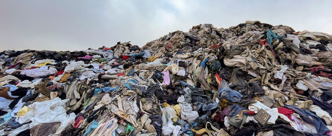 View of used clothes discarded in the Atacama desert, in Alto Hospicio, Iquique, Chile, on September 26, 2021. - EcoFibra, Ecocitex and Sembra are circular economy projects that have textile waste as their raw material. The textile industry in Chile will be included in the law of Extended Responsibility of the Producer (REP), forcing clothes and textiles importers take charge of the waste they generate. (Photo by MARTIN BERNETTI / AFP)