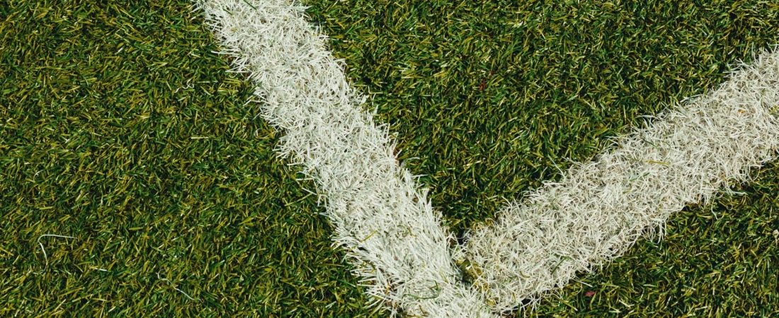 green grass field with white paint