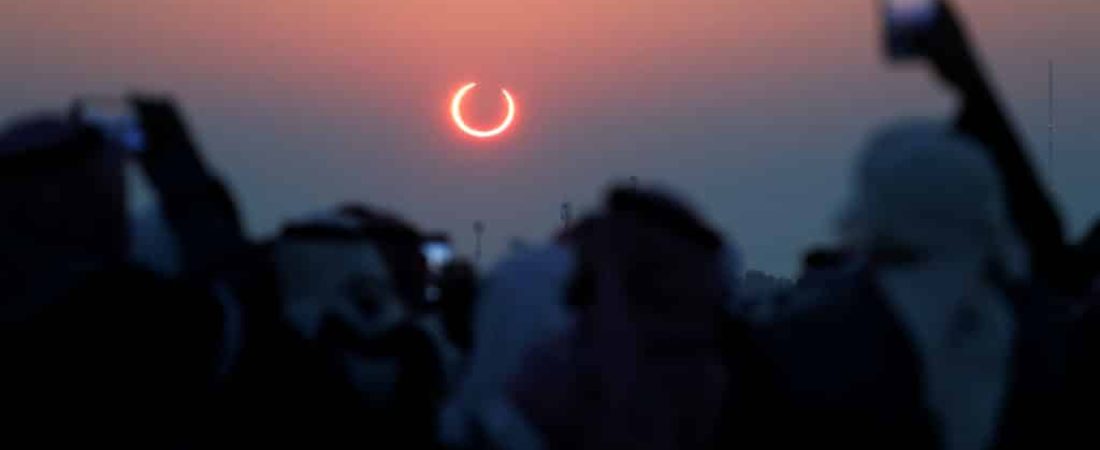 People take photos with their smartphones as they monitor the annular solar eclipse on Jabal Arba (Four Mountains) in Hofuf, in the Eastern Province of Saudi Arabia, December 26, 2019. REUTERS/Hamad I Mohammed