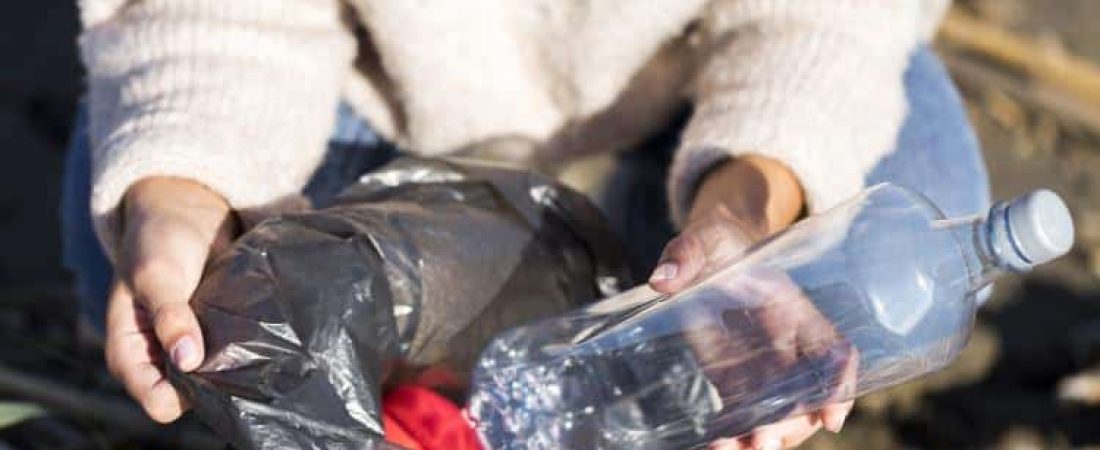 woman-picking-trash-from-seaside